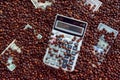 Calculator and a few dollars on the background of coffee beans Royalty Free Stock Photo