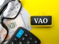Calculator,glasses and banknotes with word VOA Royalty Free Stock Photo