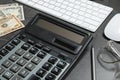 Calculator, glasses, money and keyboard on grey table, closeup. Tax accounting Royalty Free Stock Photo