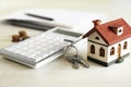 Calculator, house model, keys and documents. Real estate agent`s workplace Royalty Free Stock Photo