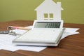 Calculator, house model, keys and documents on table. Real estate agent`s workplace Royalty Free Stock Photo