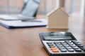 calculator & house model at real estate office. mortgage & property concept Royalty Free Stock Photo