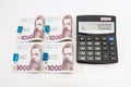 Calculator and 1000 hryvnia fastened by a clip on white Royalty Free Stock Photo