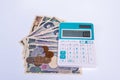 calculator with Japanese currency yen bank notes and coin on fin Royalty Free Stock Photo