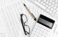 Calculator, keyboard, pen and eye glasses lying on financial statement . Financial concept Royalty Free Stock Photo