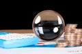 Calculator, magnifying glass and coins related to financial investment Royalty Free Stock Photo