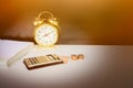 Calculator, money and alarm clock old vintage gold over white and black background. with copy space add text retro style Royalty Free Stock Photo