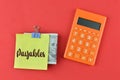 Calculator, money banknote and memo note written with PAYABLES Royalty Free Stock Photo