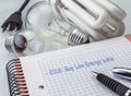 Calculator and money next to a light bulb, writing in agenda year 2018 to buy bulbs of low consumption Royalty Free Stock Photo