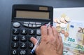 Calculator, money, pen and envelope on the table. Money counting