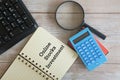 calculator and note book on wooden background. Online Stocks investment