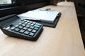 calculator & notebook on accountant desk. bookeeper, financial i