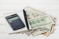 Calculator, notebook, pen and cash money on white table. Royalty Free Stock Photo