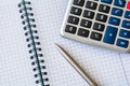 Calculator and notebook with pen on desktop Royalty Free Stock Photo