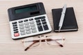 Calculator, notepad, pen and glasses on table Royalty Free Stock Photo