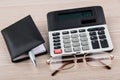 Calculator, notepad, pen and glasses on table Royalty Free Stock Photo