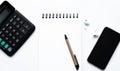 calculator, notepad, spiral notebook, pen, AirPods, headphones, on white background top view