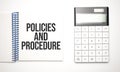 calculator and notepad with text Policies and Procedure Royalty Free Stock Photo