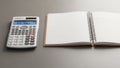 Spiral notebook on a gray surface. The calculator displays 123 456 on an Royalty Free Stock Photo