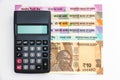 Calculator over brand new indian 10, 50, 100, 200, 500 and 2000 rupees banknotes. Colorful money background Royalty Free Stock Photo