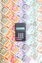 Calculator over brand new indian 10, 50, 100, 200, 500 and 2000 rupees banknotes. Colorful money pattern Royalty Free Stock Photo