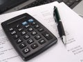 Calculator and pen with balance sheet Royalty Free Stock Photo
