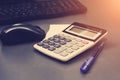 Calculator, pen, computer lie on the desk. Business Financing Accounting Banking Concept. Tinted photograph Royalty Free Stock Photo