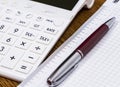 A calculator and a pen on desk