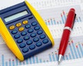 Calculator and pen on earnings chart Royalty Free Stock Photo