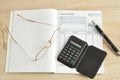 Calculator, pen, glasses and invoice book