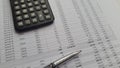 Calculator and a pen laying on financial report business balance. Business accounting concept