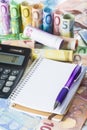 Calculator pen and notebook on the money Royalty Free Stock Photo