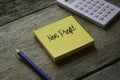 Calculator,pencil and yellow sticky notes written with Non Profit on wooden background