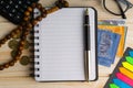 Calculator, rosary, coins, banknotes, book, spectacle and pen on wooden background Royalty Free Stock Photo