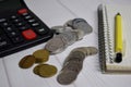 Calculator and the stack of coint isolated on office desk. calculating salary or tax concept Royalty Free Stock Photo