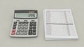 Calculator and Stack of Financial Documents on Desk Royalty Free Stock Photo