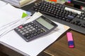 Calculator, staple and business documents stack Royalty Free Stock Photo