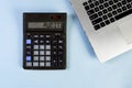 Calculator text AUDIT and laptop on the blue background