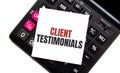 Calculator with text Client Testimonials with white paper Royalty Free Stock Photo