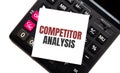 Calculator with text COMPETITOR ANALYSIS with white paper