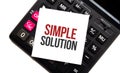 calculator with text SIMPLE SOLUTION with white paper