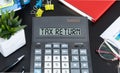 Calculator with text Tax Return, office desk at the back. Business, finance conceptual Royalty Free Stock Photo