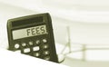 Calculator with the word FEES on the display beach landscape . Taxes concept Royalty Free Stock Photo