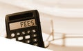 Calculator with the word FEES on the display beach landscape . Taxes concept Royalty Free Stock Photo