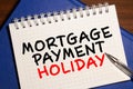 Calculator with the word 'Help' and Notepad with text 'Mortgage Payment Holiday Royalty Free Stock Photo