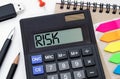 Calculator with the word risk on the display. Money, finance and business concept Royalty Free Stock Photo