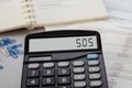 Calculator with the word sos on display Royalty Free Stock Photo