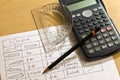 Calculators, pen, protractor and tables Royalty Free Stock Photo