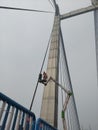 High altitude repairing works on vidyasagar setu or second hooghly bridge bridge going on with two workers standing on ladder