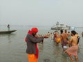 An Indian sadhu performing rituals of Makar Sankranti, the Ganges puja or worship in holy water Royalty Free Stock Photo